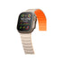 Smartwatch with a metallic band and orange strap on a white background
