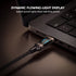 Laptop with a dynamic flowing-light display cable connected, showing real-time power on a dark surface.