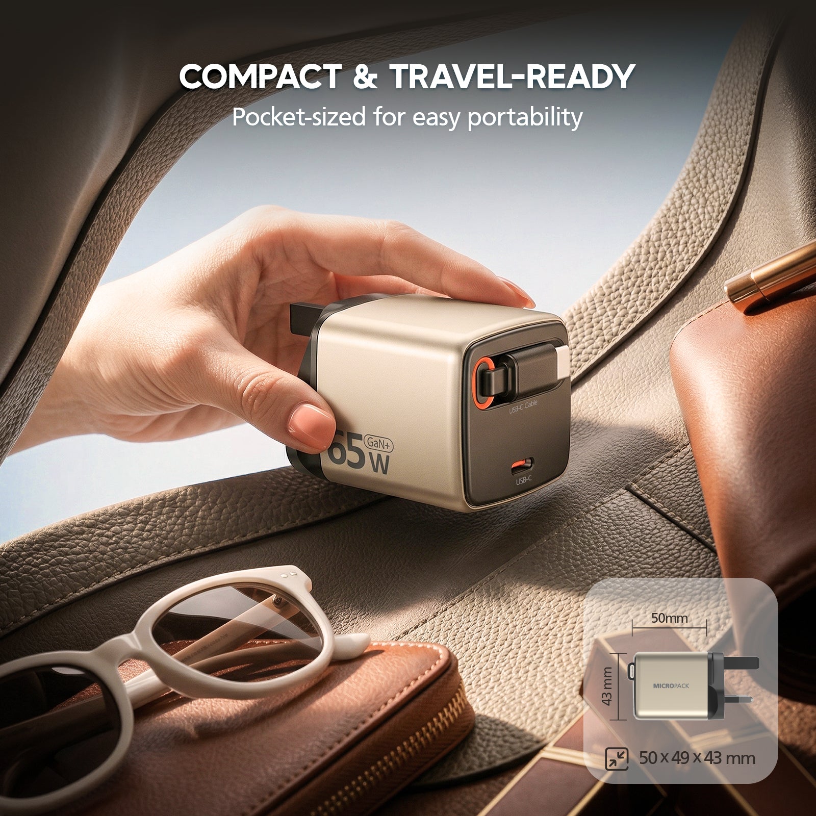 Compact power adapter being held over a car seat with sunglasses and a wallet, emphasizing portability.