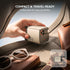 Compact power adapter being held over a car seat with sunglasses and a wallet, emphasizing portability.