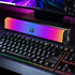 Gaming keyboard and RGB light bar on a desk with computer monitor in the background