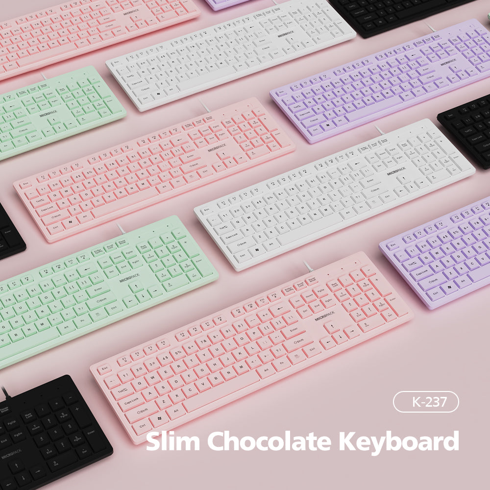 Collection of slim chocolate keyboards in various pastel colors on a pink background.