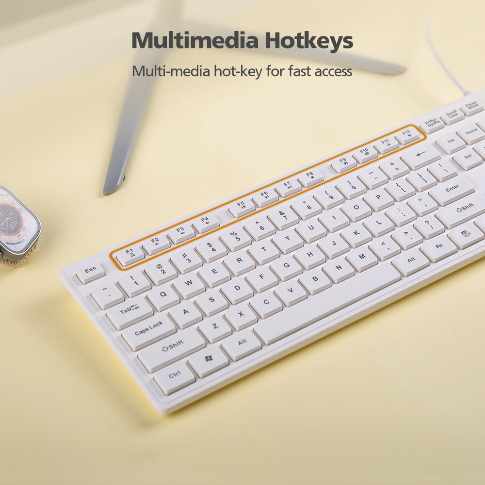 White keyboard with multimedia hotkeys on a light yellow background