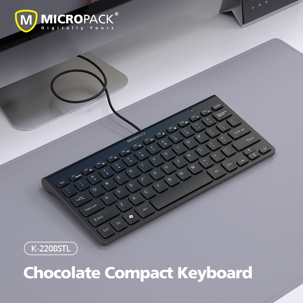 Chocolate Compact Keyboard by MicroPack on a desk with a computer monitor in the background.