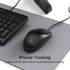 Black computer mouse on a desk with keyboard and text about precise tracking.