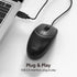 Black computer mouse with USB cable connected to a laptop on a white background