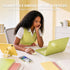Woman using a green laptop with text about Bluetooth connectivity