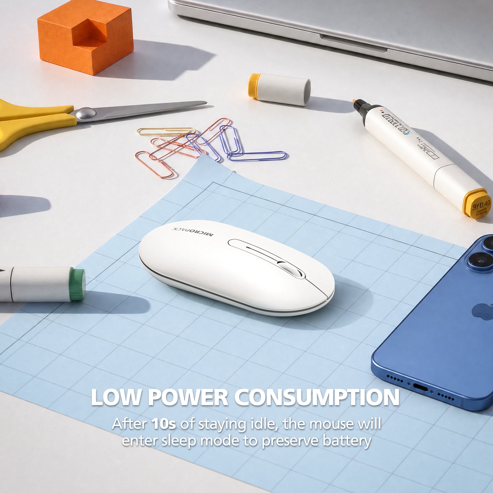 White mouse on a blue mouse pad with office supplies on a desk