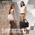 Two models wearing sleeveless tops and wide-leg trousers pose on white geometric stairs, each carrying a puffy protective sleeve bag. One bag is white and worn crossbody, while the other is black and carried in one hand.