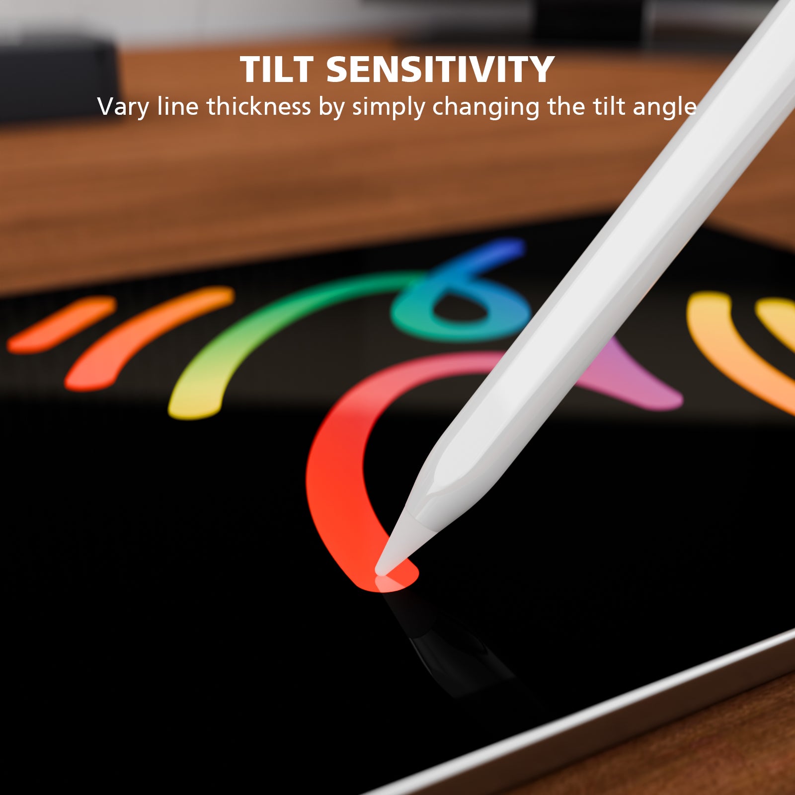 A close-up of a white stylus pen drawing on a tablet screen, with text at the top reading 'TILT SENSITIVITY' and smaller copy explaining that line thickness varies by tilt angle. The scene is set on a wooden surface.