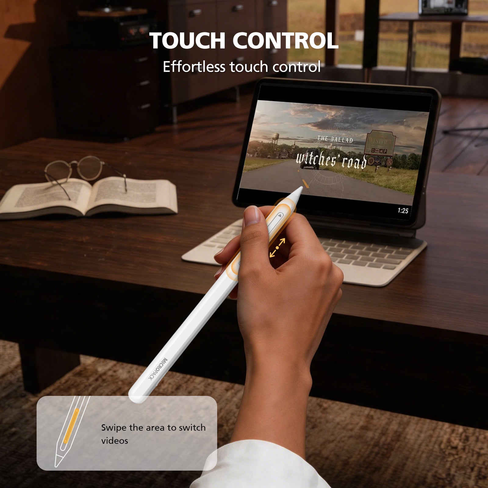 Person using a stylus with a tablet on a desk, emphasizing touch control.