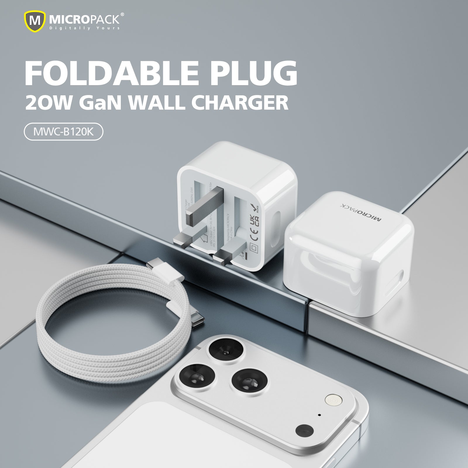 MICROPACK foldable plug 20W GaN wall charger shown in both folded and unfolded states, alongside a white braided charging cable and a smartphone, on a clean gray reflective surface.